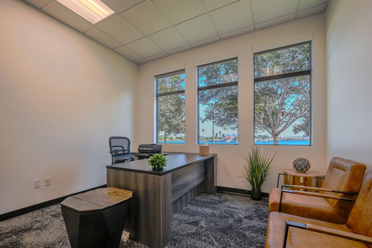 Suite 105 at The Work Quarters, with San Diego Bay visible through three tall windows