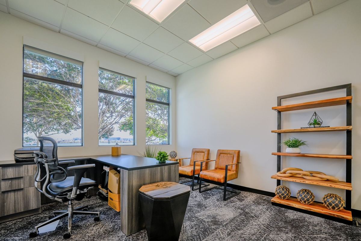 Suite 105: executive desk, timber library shelving and leather club chairs